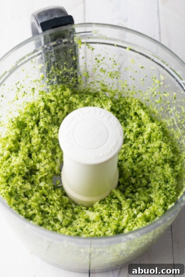 A close-up view of the riced broccoli florets, showcasing their uniform size and readiness to be combined and roasted.