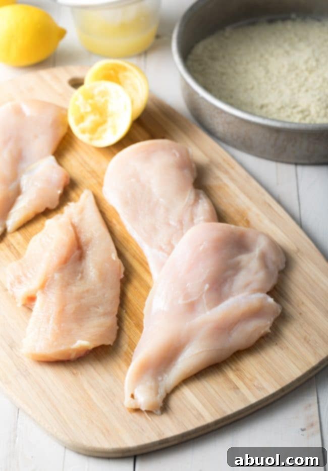 Crispy Chicken Piccata Recipe: Chicken breast being cut into thin cutlets.