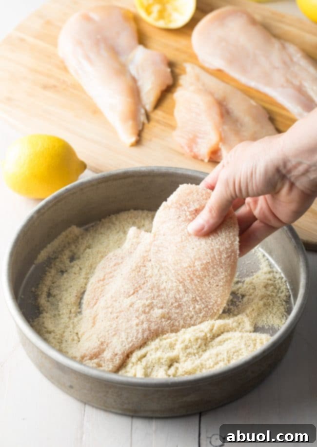 Chicken cutlets coated in almond flour, ready for frying.