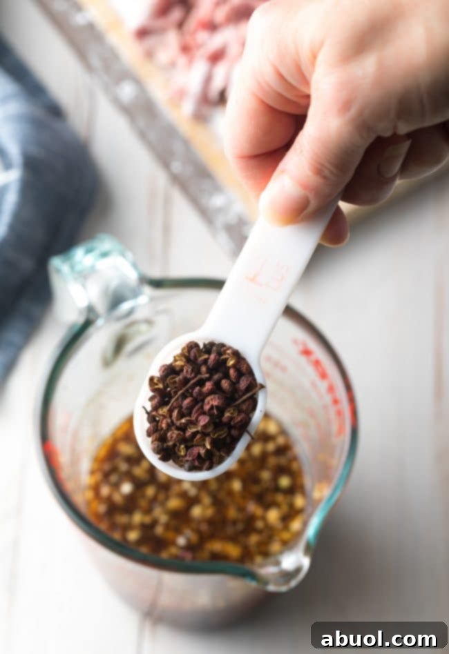 Close-up of Szechuan Peppercorns, highlighting their unique texture and vibrant color—the secret to authentic Szechuan heat and numbing sensation.