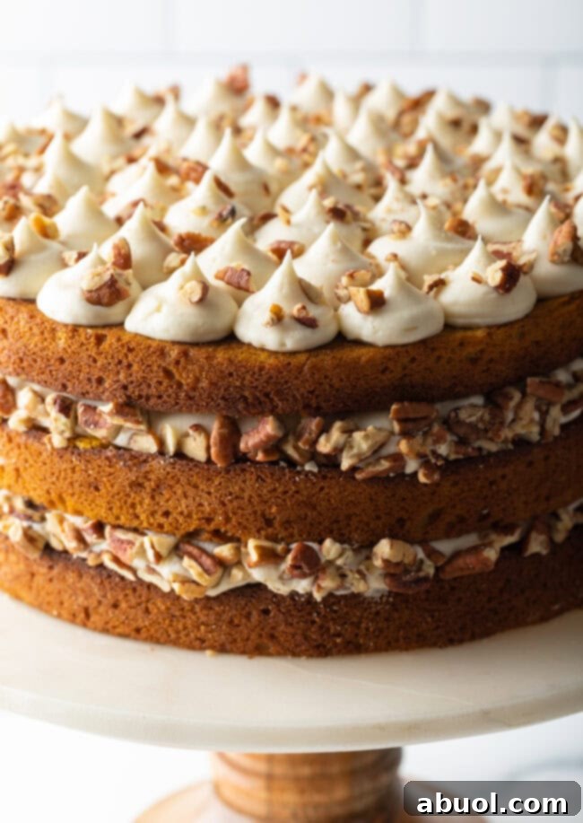 Spiced Autumn Pumpkin Cake 10 Pumpkin spice cake on a stand.