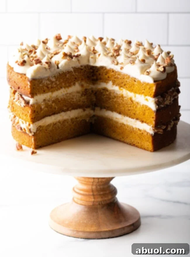 Spiced Autumn Pumpkin Cake 12 Sliced spiced pumpkin cake on a stand.