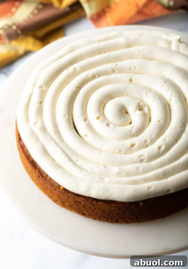Spiced Autumn Pumpkin Cake 8 First layer of cake topped off with swirl of frosting.