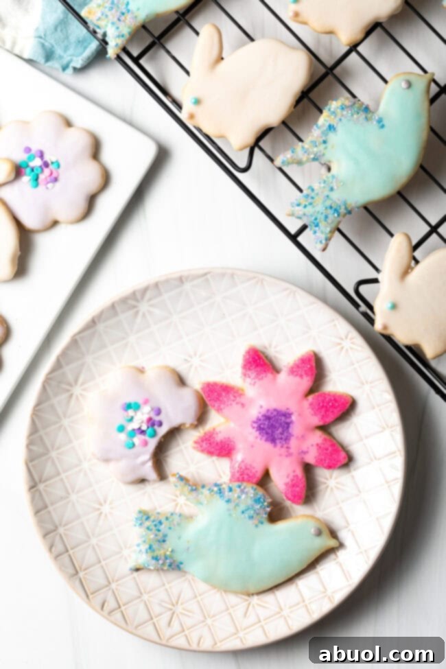 Beautifully decorated roll-out sugar cookies served on a white plate, showcasing their inviting appearance.