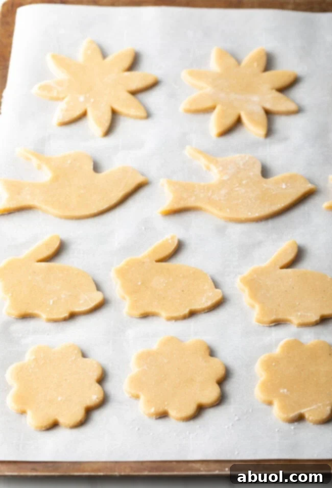 Unbaked cut-out cookie dough shaped and ready for the oven, demonstrating precision in cookie making.
