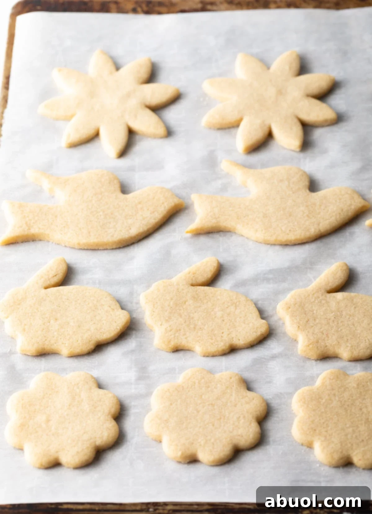 Freshly baked cut-out cookies cooling on a rack, showcasing their perfect shape and golden-brown edges.