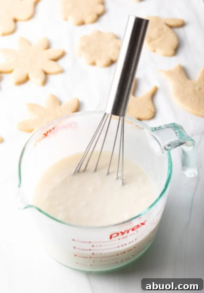 A bowl of whisked sugar cookie icing, ready for decorating delicious cut-out cookies.