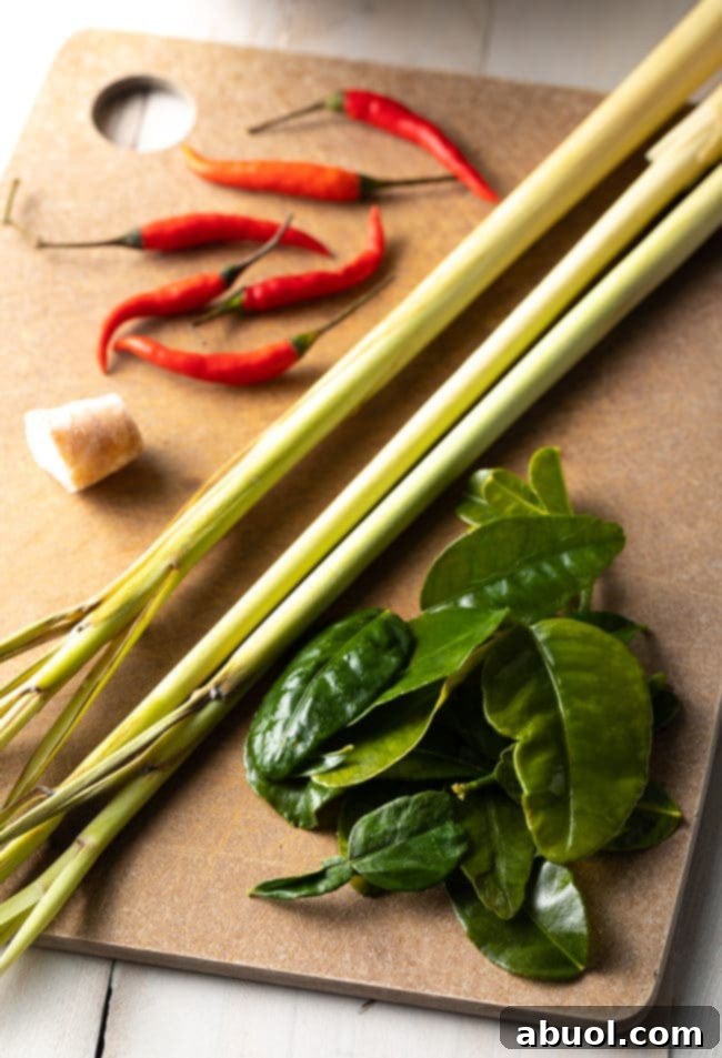 Spicy Thai Tom Yum Perfection 6 Ingredients for tom yum soup on a cutting board.