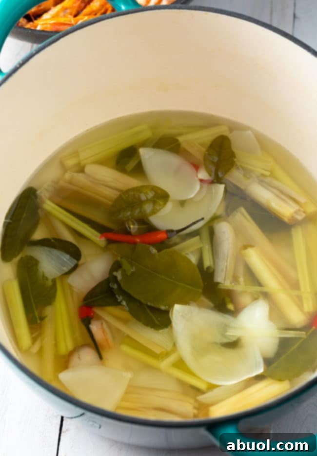 Spicy Thai Tom Yum Perfection 8 Lime kefir leaves and lemongrass stalks in a broth.