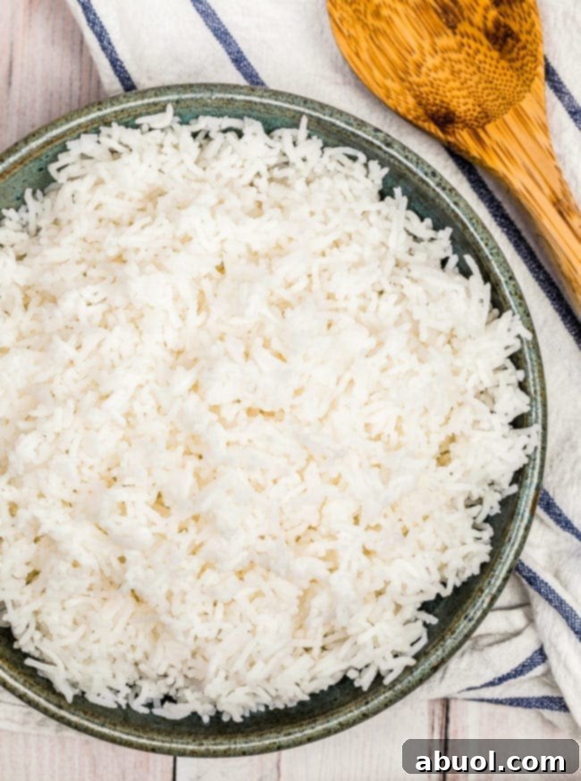 A top down view of perfectly cooked fluffy basmati rice in a gray bowl, ready to be served.