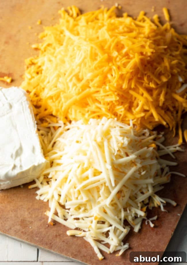 Homemade Mac and Cheese Perfection 7 Three cheeses for the recipe - shredded sharp cheddar, shredded muenster, and block of cream cheese