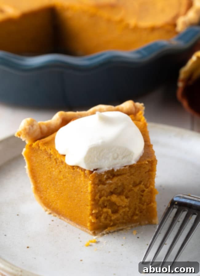 A whole Southern Sweet Potato Pie, freshly baked with a golden-brown crust, sitting on a wooden surface, ready for a festive gathering.