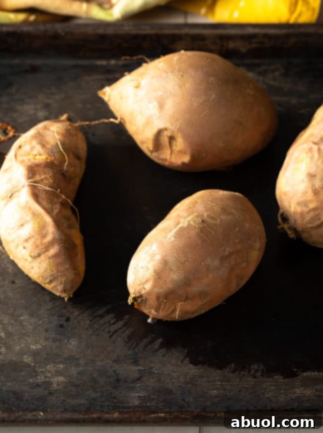 Close-up of perfectly baked sweet potatoes, prepared and ready to be mashed for a delightful old-fashioned sweet potato pie recipe.