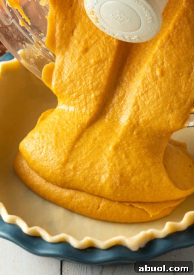 A delicious Thanksgiving pie recipe, a golden-brown sweet potato pie cooling on a wire rack, ready to be served.