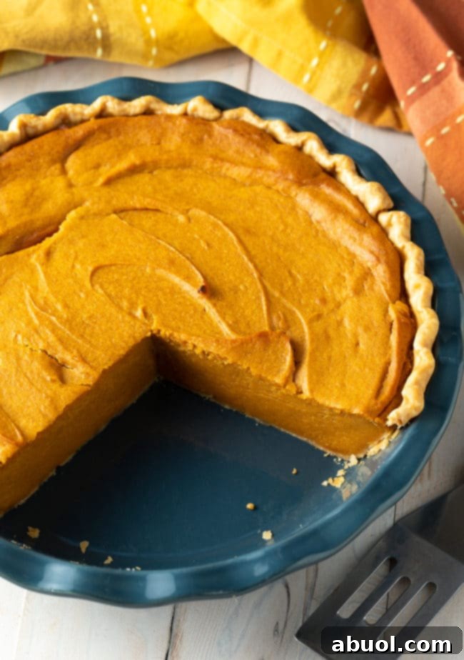 An easy sweet potato pie recipe, with several slices cut out, showing its rich, smooth filling and inviting golden crust, perfect for serving.