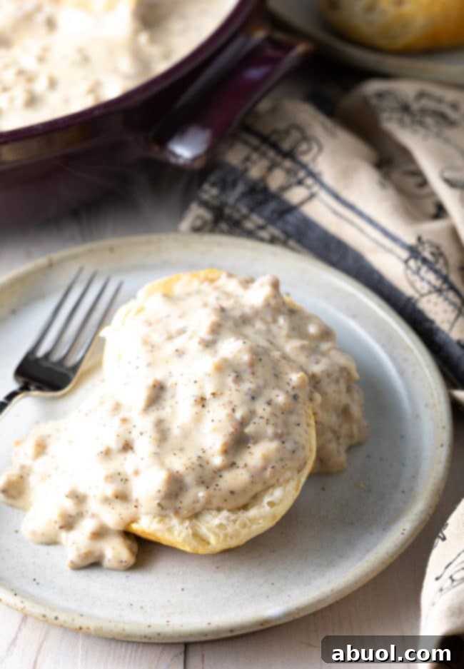 Effortless Sausage Gravy 6 fluffy cathead biscuits covered in white sausage gravy