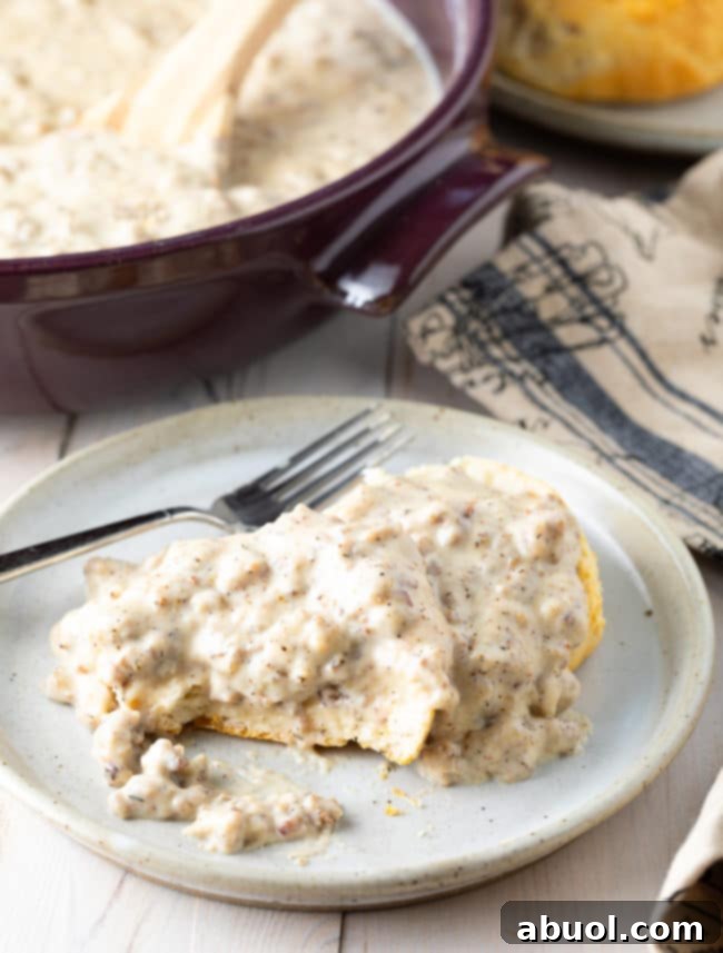 Effortless Sausage Gravy 7 Easy Sausage Gravy and Biscuits on a plate.