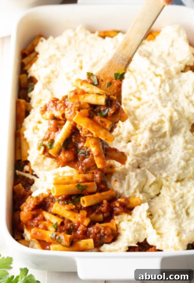 Cheesy Sausage Ziti Bake 3 Ricotta Baked Ziti Recipe being layered in a baking pan