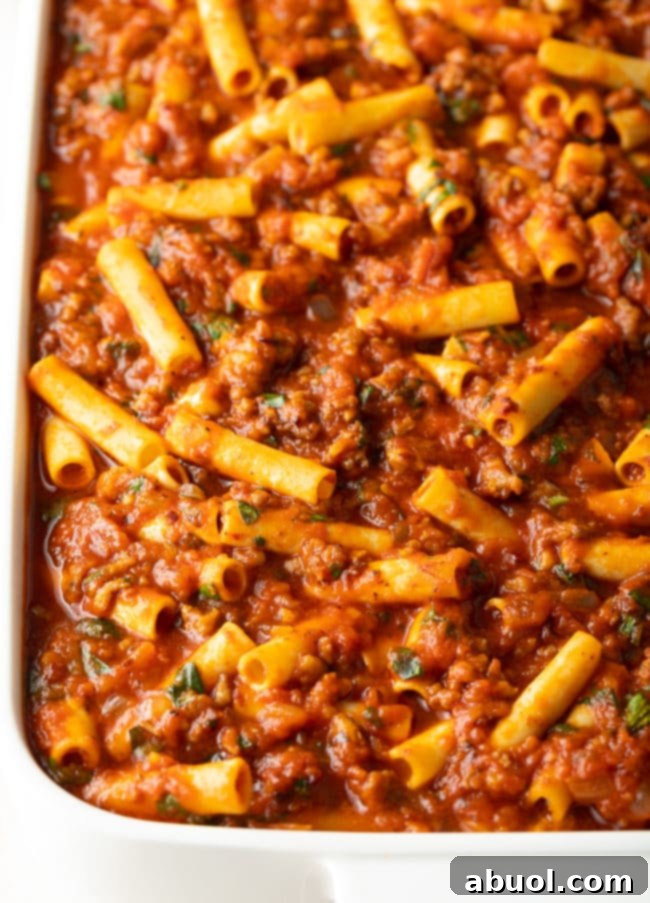 pasta-dinner Ziti, sauce, sausage, and cheese combined in a baking dish, ready for the oven