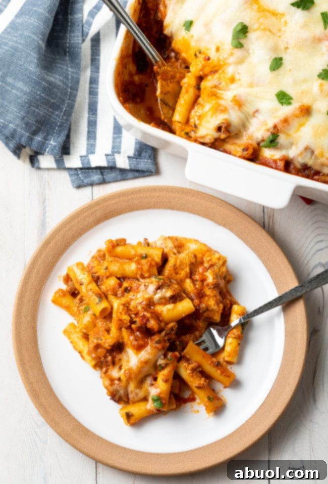 baked-ziti A serving of baked ziti with sausage and ricotta on a white plate, ready to be enjoyed