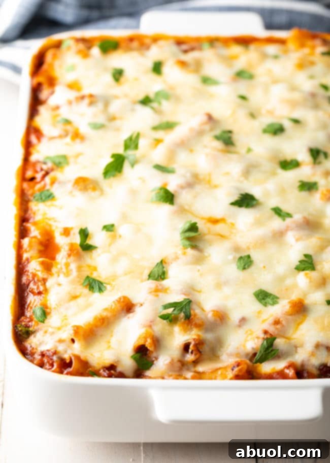 non-boiled-pasta Baked ziti with Italian sausage in a casserole dish, before being served, highlighting the no-boiled pasta method