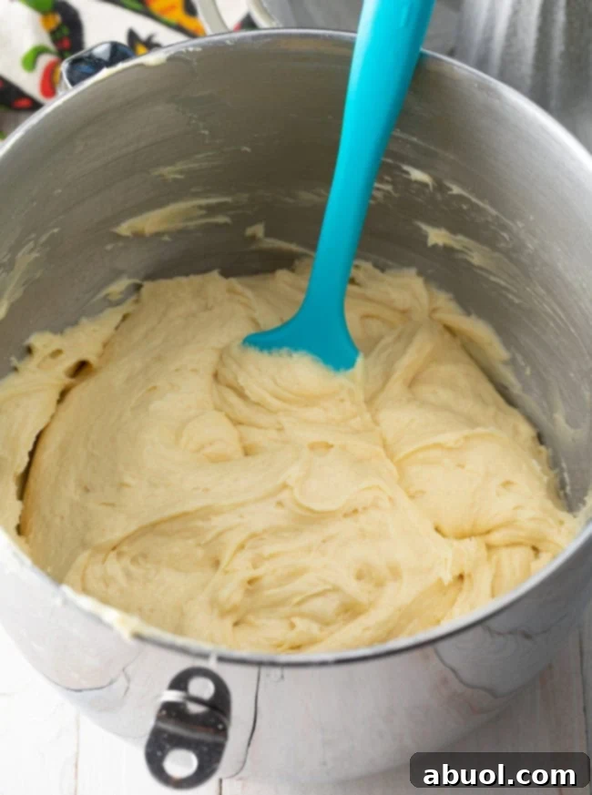 Close-up of creamed butter, cream cheese, and sugar in a mixing bowl.