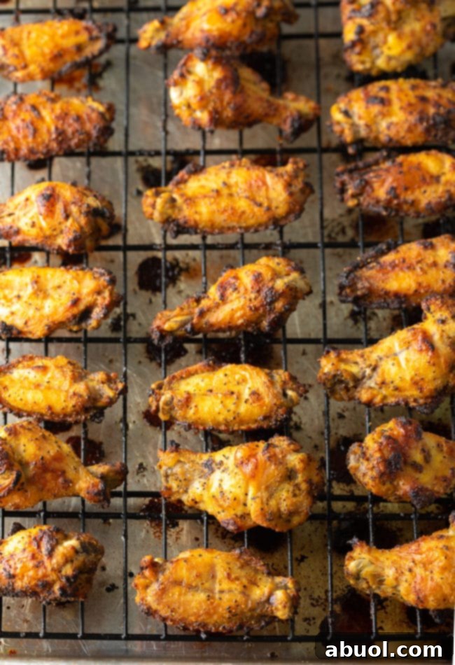 Crispy Baked Lemon Pepper Wings 13 A vibrant platter of crispy lemon pepper chicken wings, with fresh lemon slices.