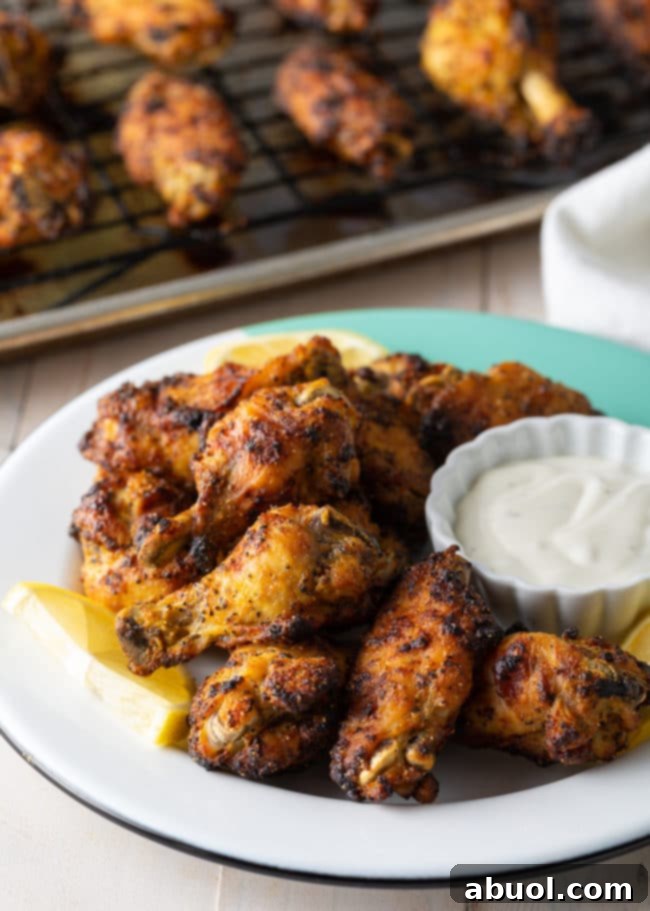 Crispy Baked Lemon Pepper Wings 15 A large serving bowl filled with baked lemon pepper chicken wings, ready to be enjoyed.