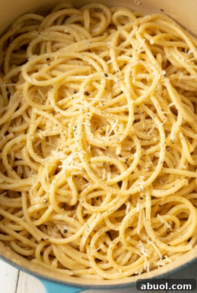 Cacio e Pepe cooking in a large blue pot, showcasing the one-pot method