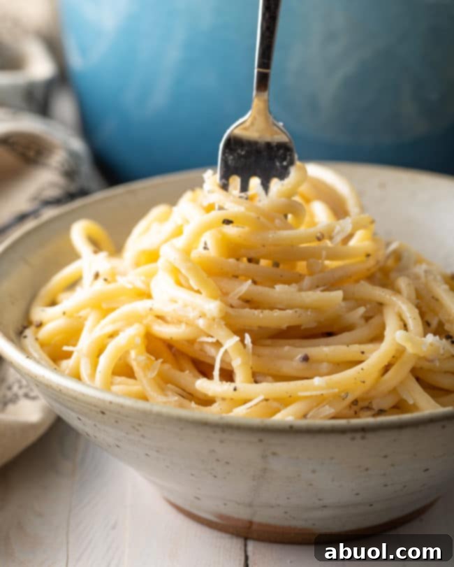 The Best Cacio e Pepe Recipe swirled on fork, tempting and delicious
