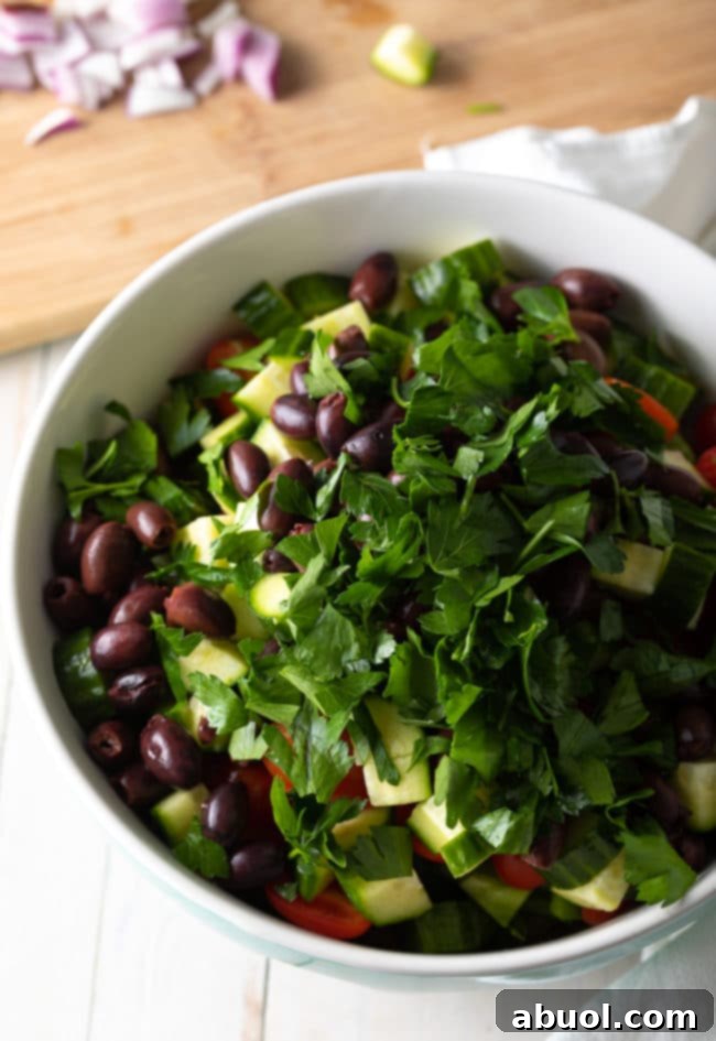 Ingredients for Greek Pasta Salad in a bowl, ready for mixing