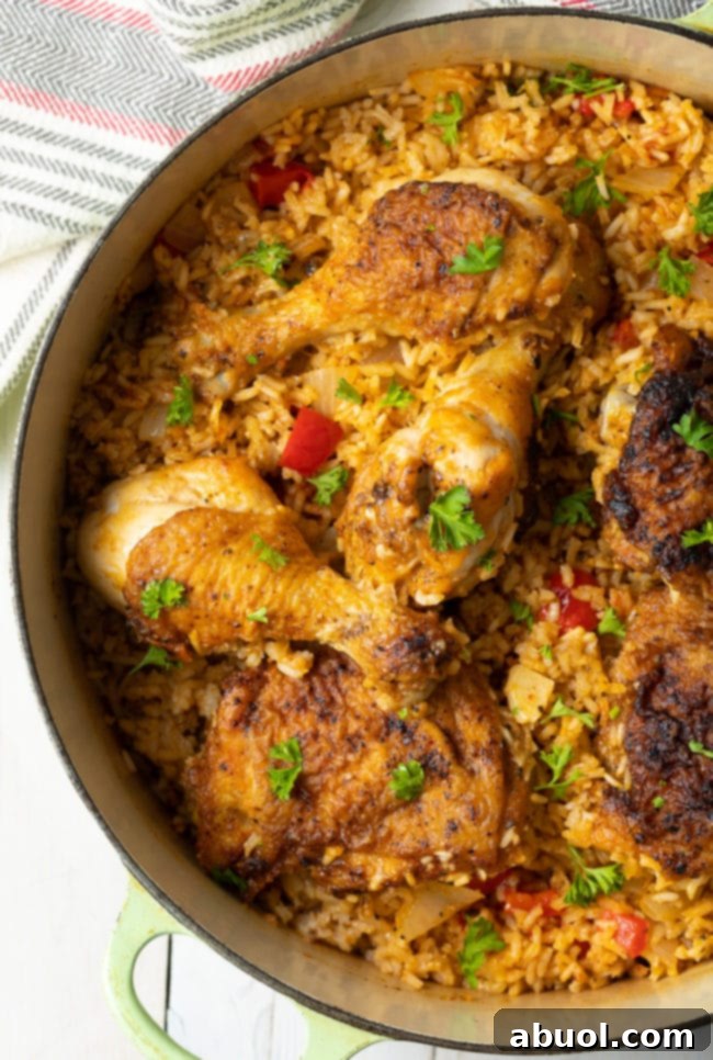Authentic Cuban Arroz Con Pollo 2 Rice and chicken in a large dutch oven, ready to be served.