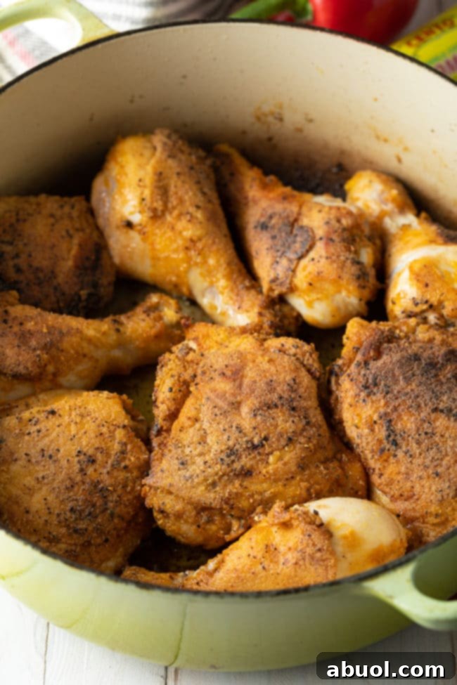 Authentic Cuban Arroz Con Pollo 6 Perfectly browned chicken pieces in a dutch oven, ready for the next steps of the recipe.
