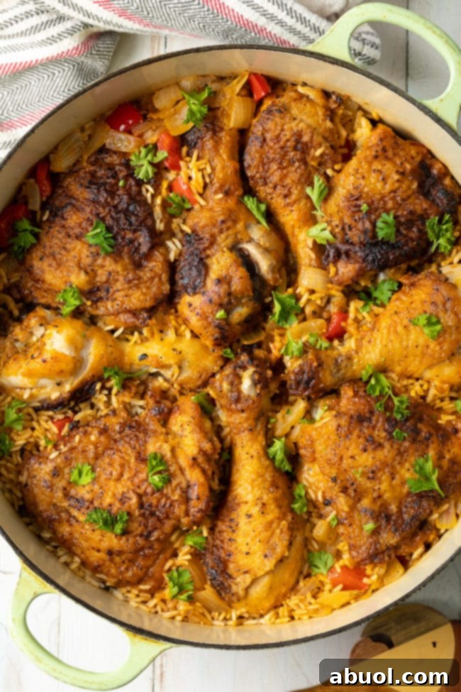 Authentic Cuban Arroz Con Pollo 9 Close-up of Arroz con Pollo Cubano in a dutch oven, showcasing its rich colors and textures.