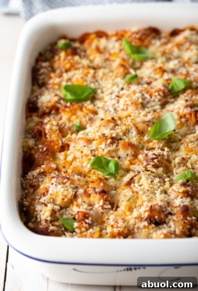 Effortless No-Boil Chicken Parmesan Pasta 3 Chicken parmesan casserole in a baking dish topped with fresh basil leaves.