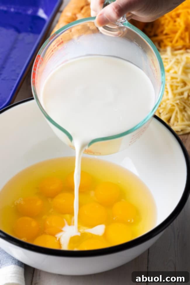 Breakfast strata mixture in a large bowl before being transferred to a baking dish