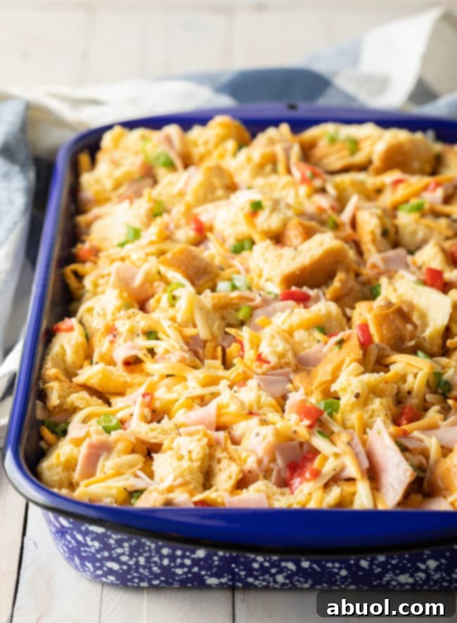 Overnight egg bake in a pan, before baking, showing bread soaked in egg mixture
