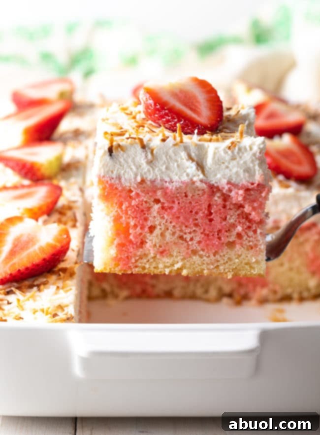 Strawberry Pineapple Jello Cake Recipe AKA Poke Cake - lifted out of the pan! A stunning cake for any occasion.