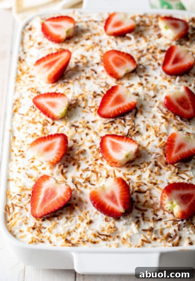 Strawberry Cake with jello and whipped topping in pan, ready to serve.