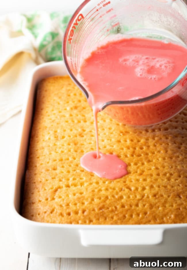 Strawberry Pineapple Poke Cake Recipe - pouring jello