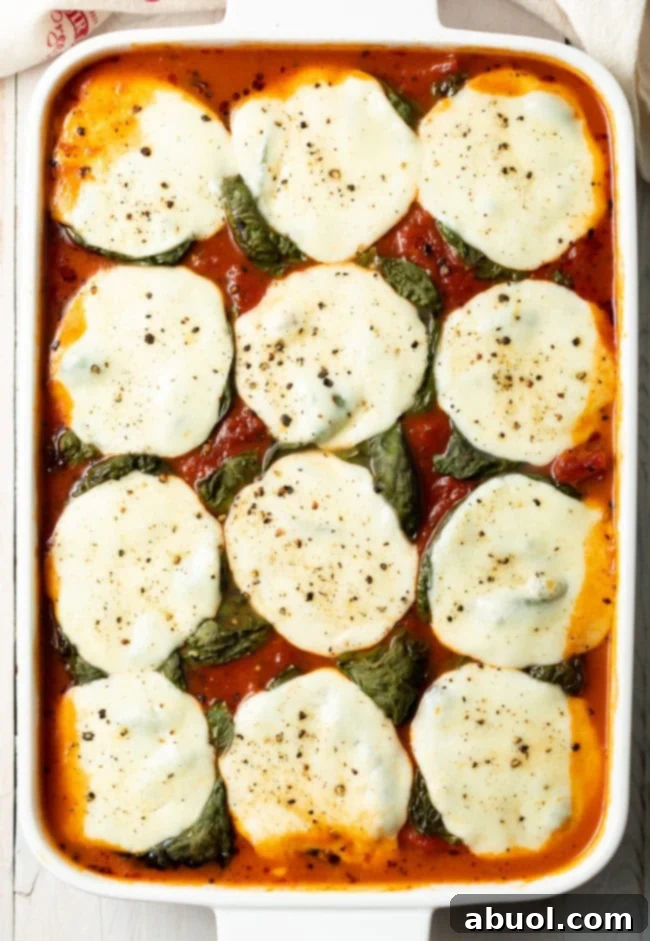 Top down view baked Italian polenta with basil and mozzarella.