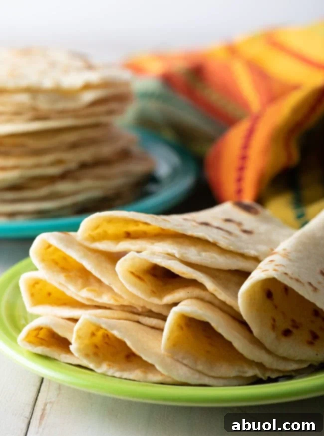 Best Flour Tortillas Recipe - soft folded tortillas on plate
