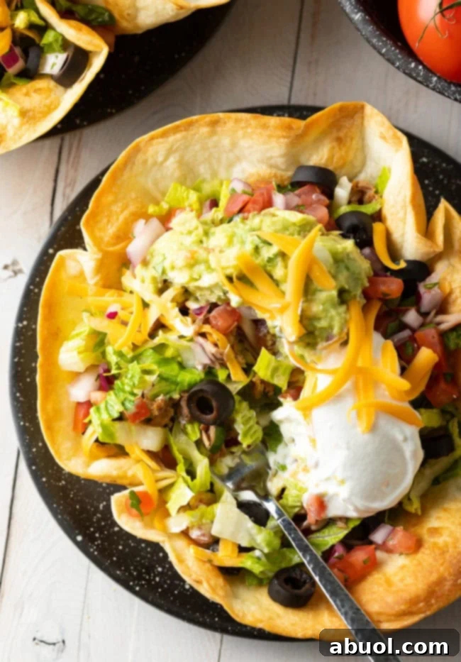 A perfectly crispy tortilla bowl filled with a fresh taco salad, presented beautifully for a satisfying meal.