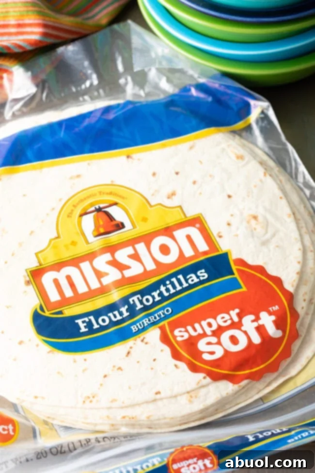 A stack of large burrito-sized flour tortillas, ready for preparation.
