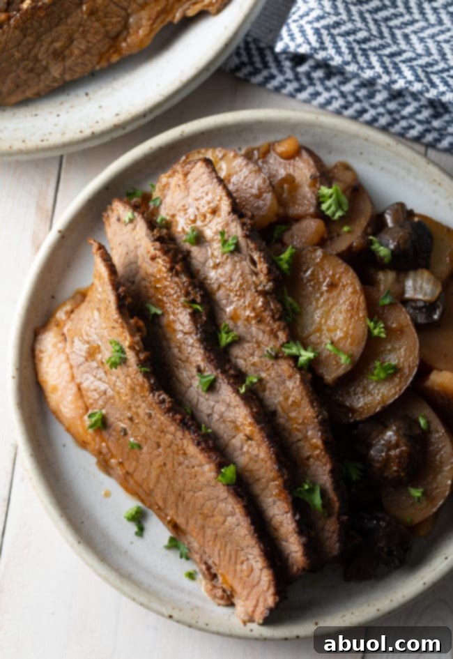 Tender Slow Cooker Beef Brisket with Potatoes and Onions, perfect for a family meal