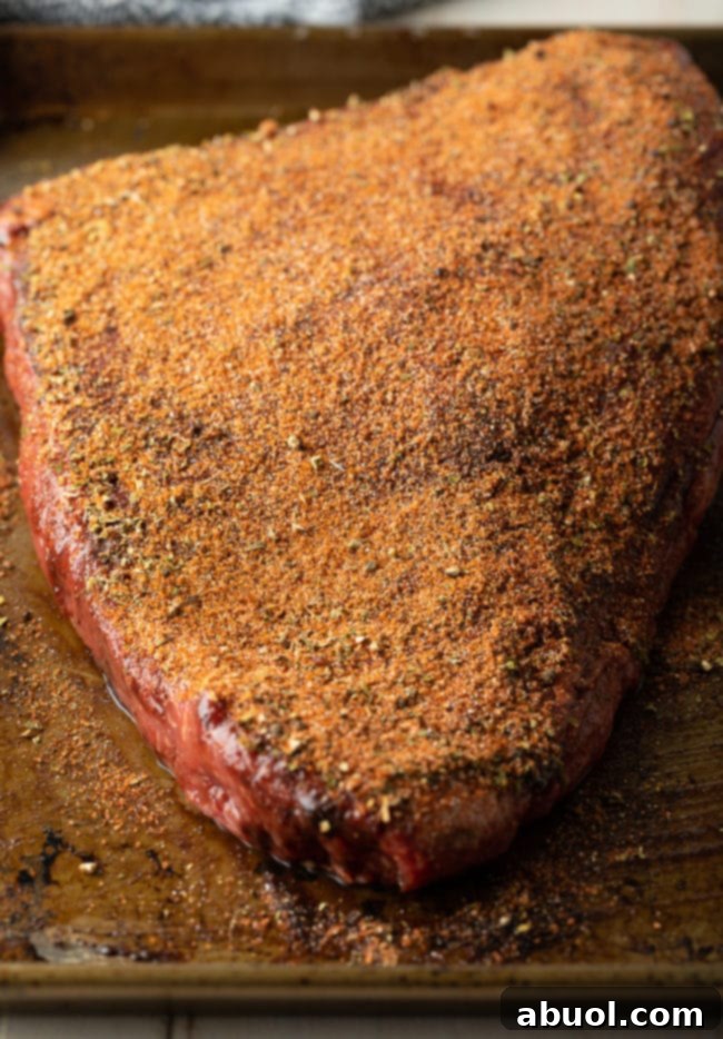 How to apply a flavorful rub to beef brisket before slow cooking