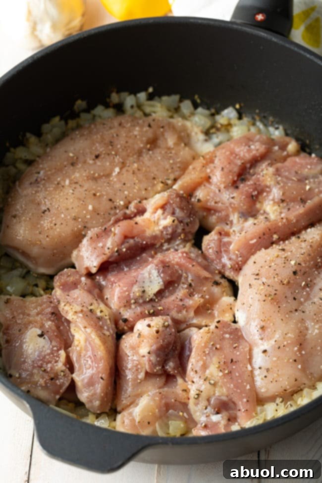 Fresh chicken thighs seasoned with salt and pepper, ready to be seared.