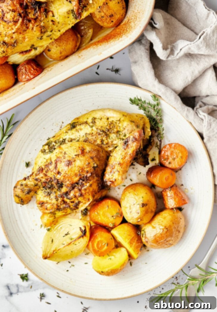 Roasted Game Hens on a bed of seasoned vegetables, captured from an overhead angle.