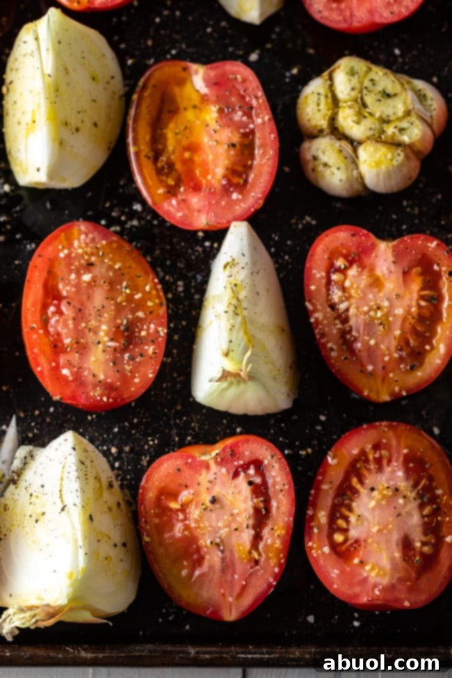 Roasted Tomato and Basil Velvet 5 Tomatoes, garlic and onion on a baking sheet to roast.