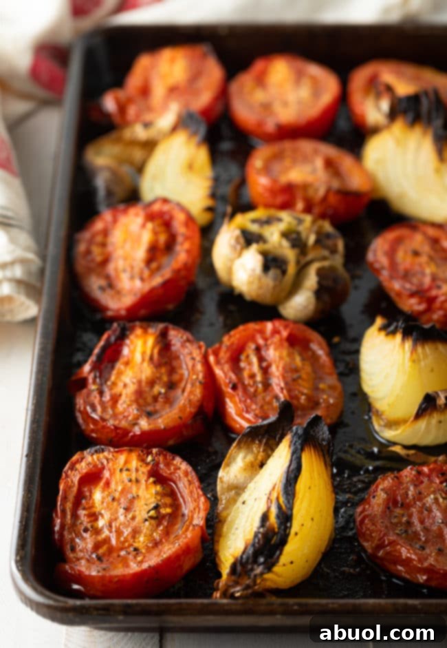 Roasted Tomato and Basil Velvet 6 roasted tomatoes, roasted garlic, and roasted onion on a baking sheet.